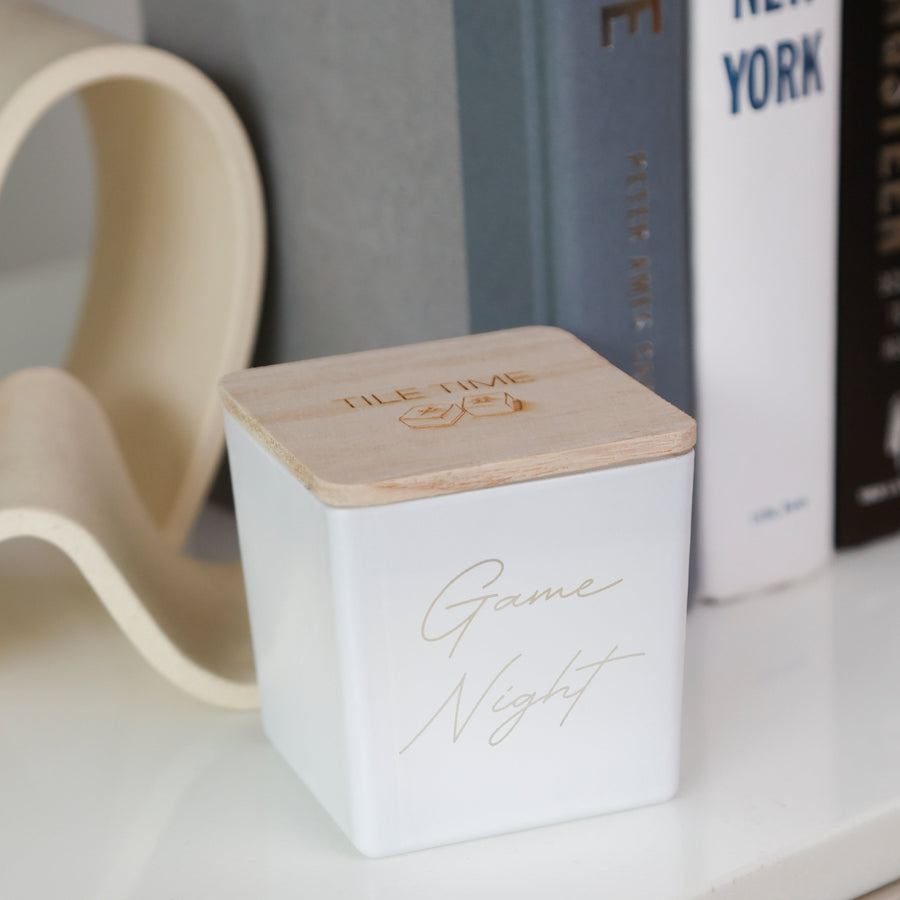 A white candle engraved Game Night
