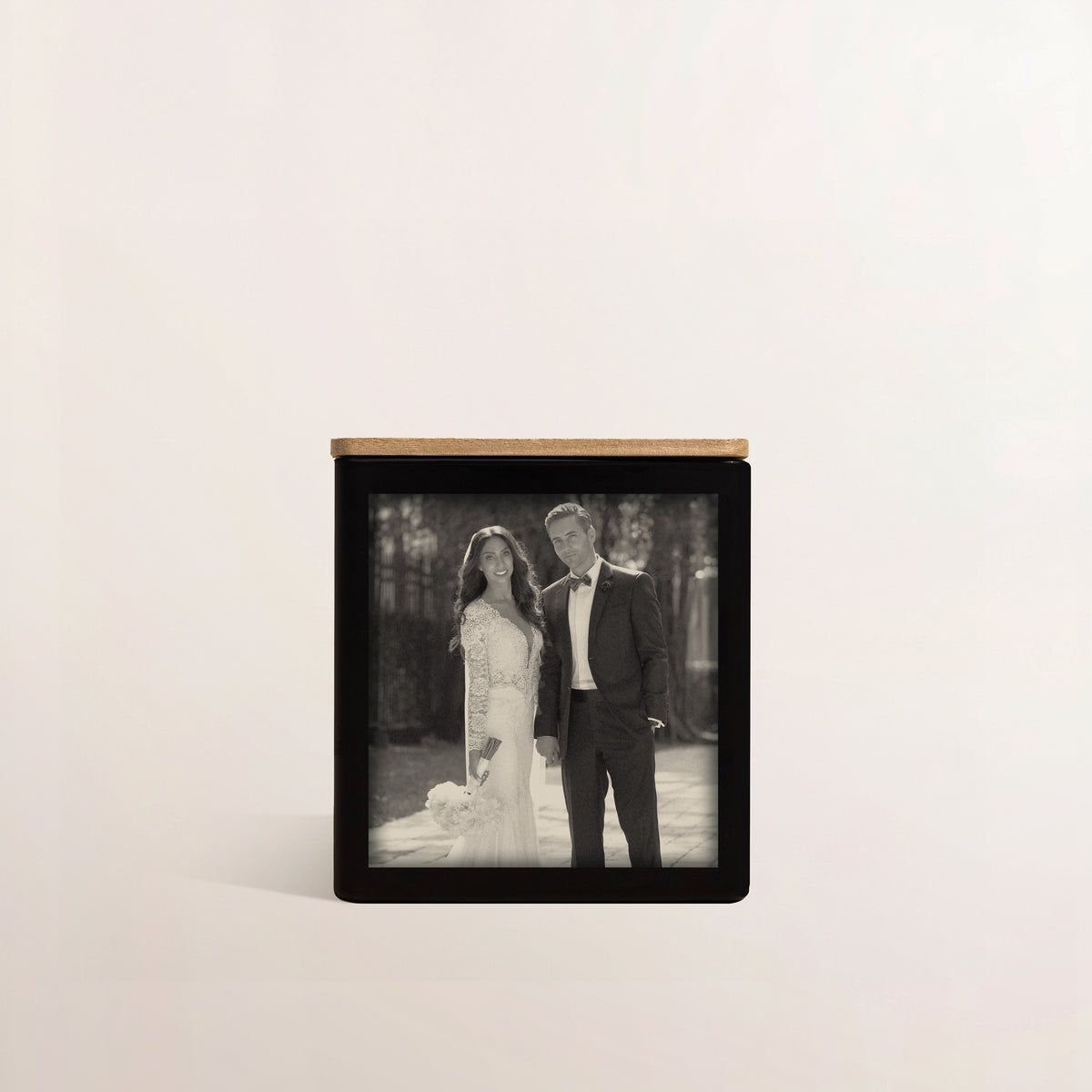 A black candle engraved with a photo