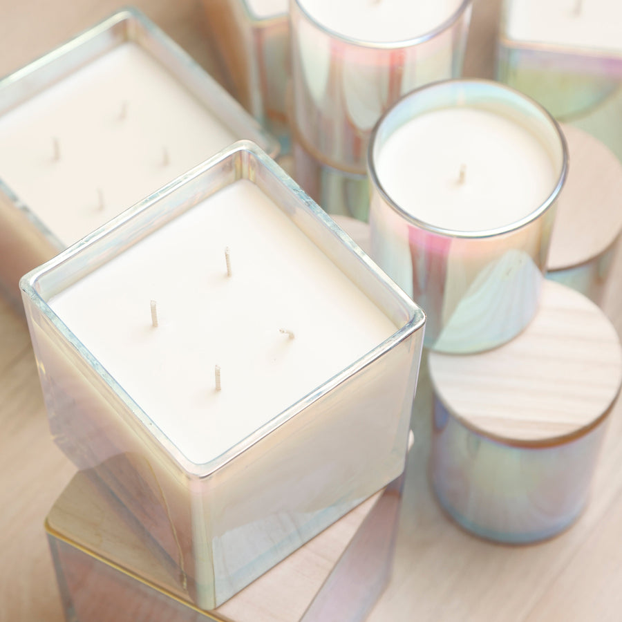 Iridescent candles with wooden lids, seen from above