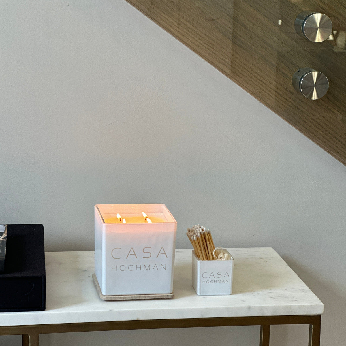 Lit white Casa bundle on a marble console