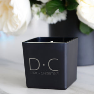 Black Classic Candle featuring a Couple Monogram design on the front, shown here as:  D • C and under it: Dirk + Christine.