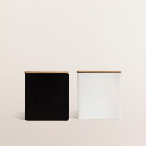 A black candle and a white candle side by side, ready to personalize