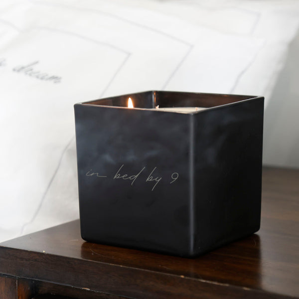 "in bed by 9" engraved on the front of the jar in TAJA's ballet font.