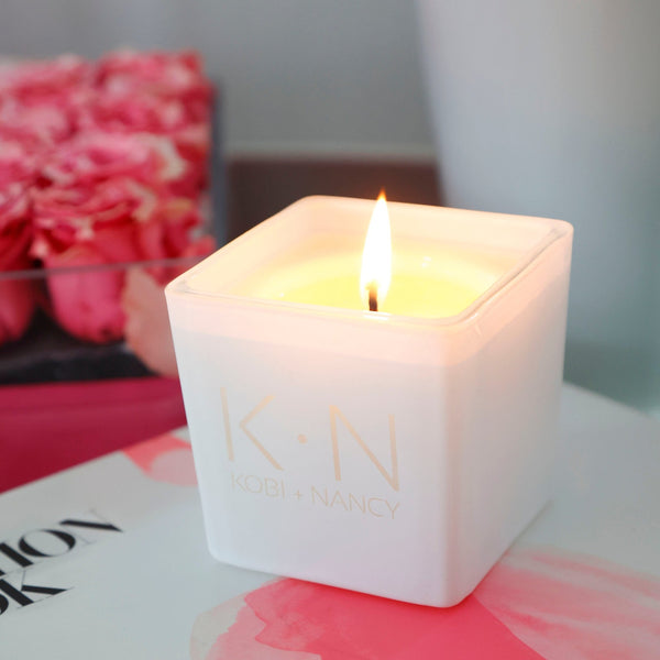 white Classic Candle featuring a Couple Monogram design on the front, shown here as:  K • N and under it: KOBI + NANCY.