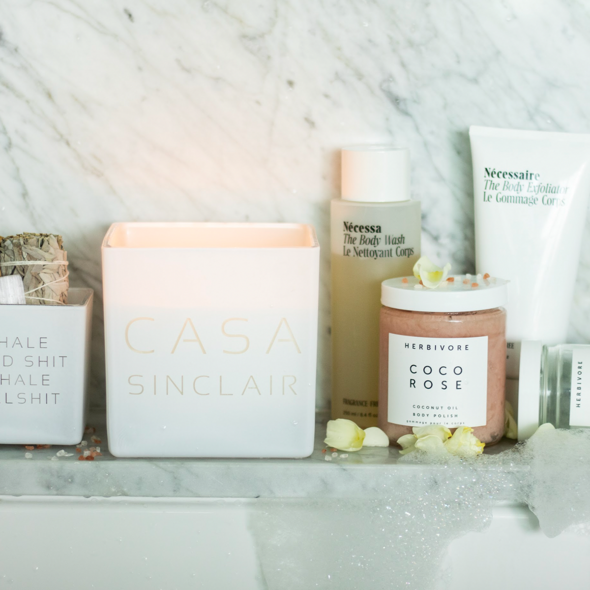 White Casa candle on a bathroom shelf