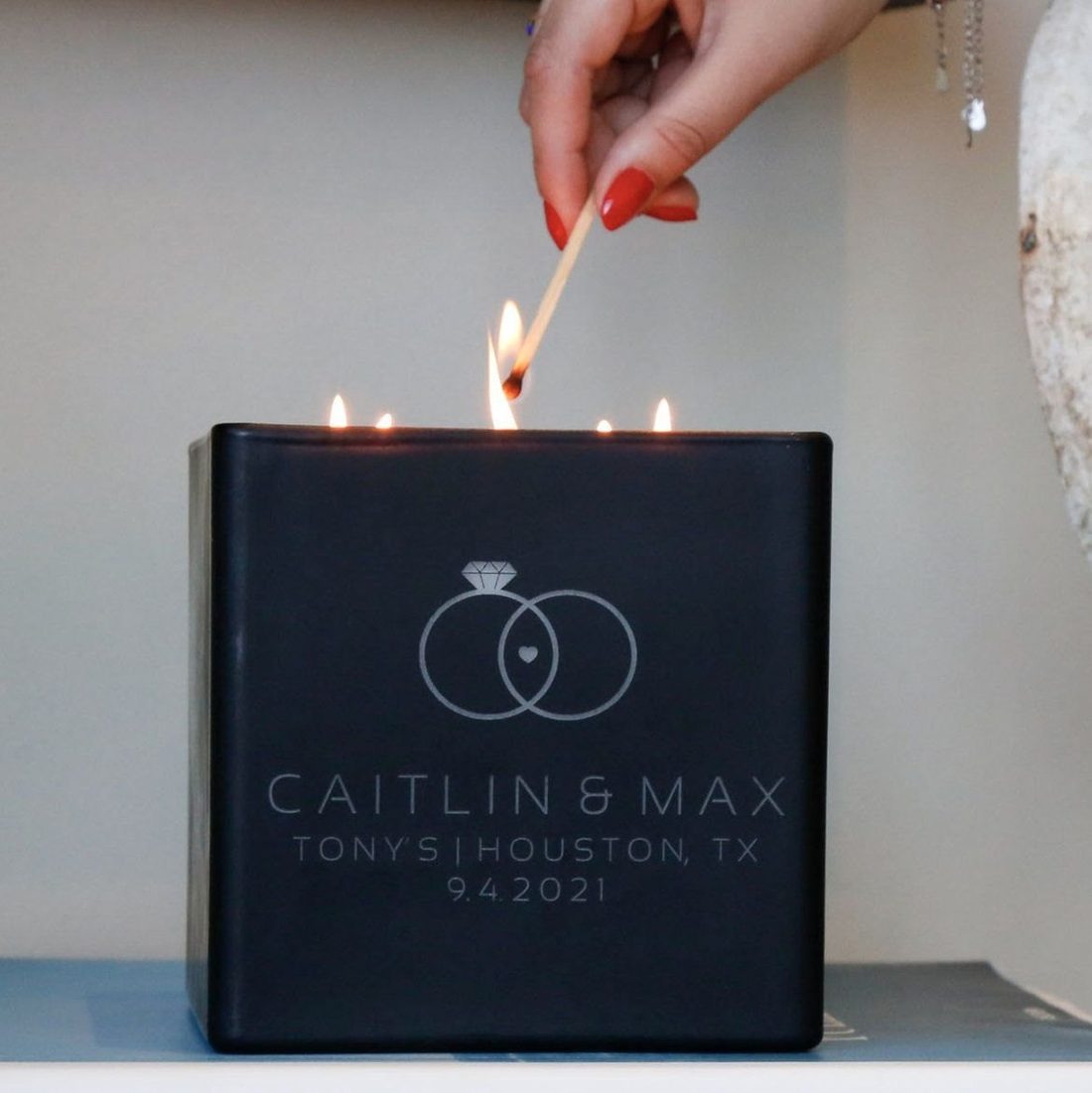 A hand lighting a wedding candle