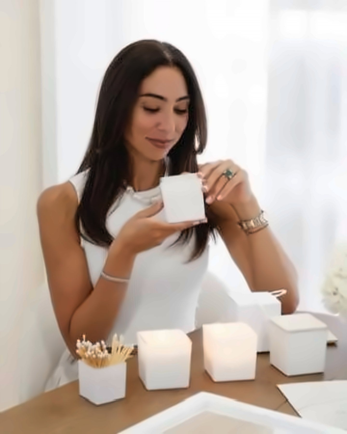 Annabelle at the studio table with white candles and matches