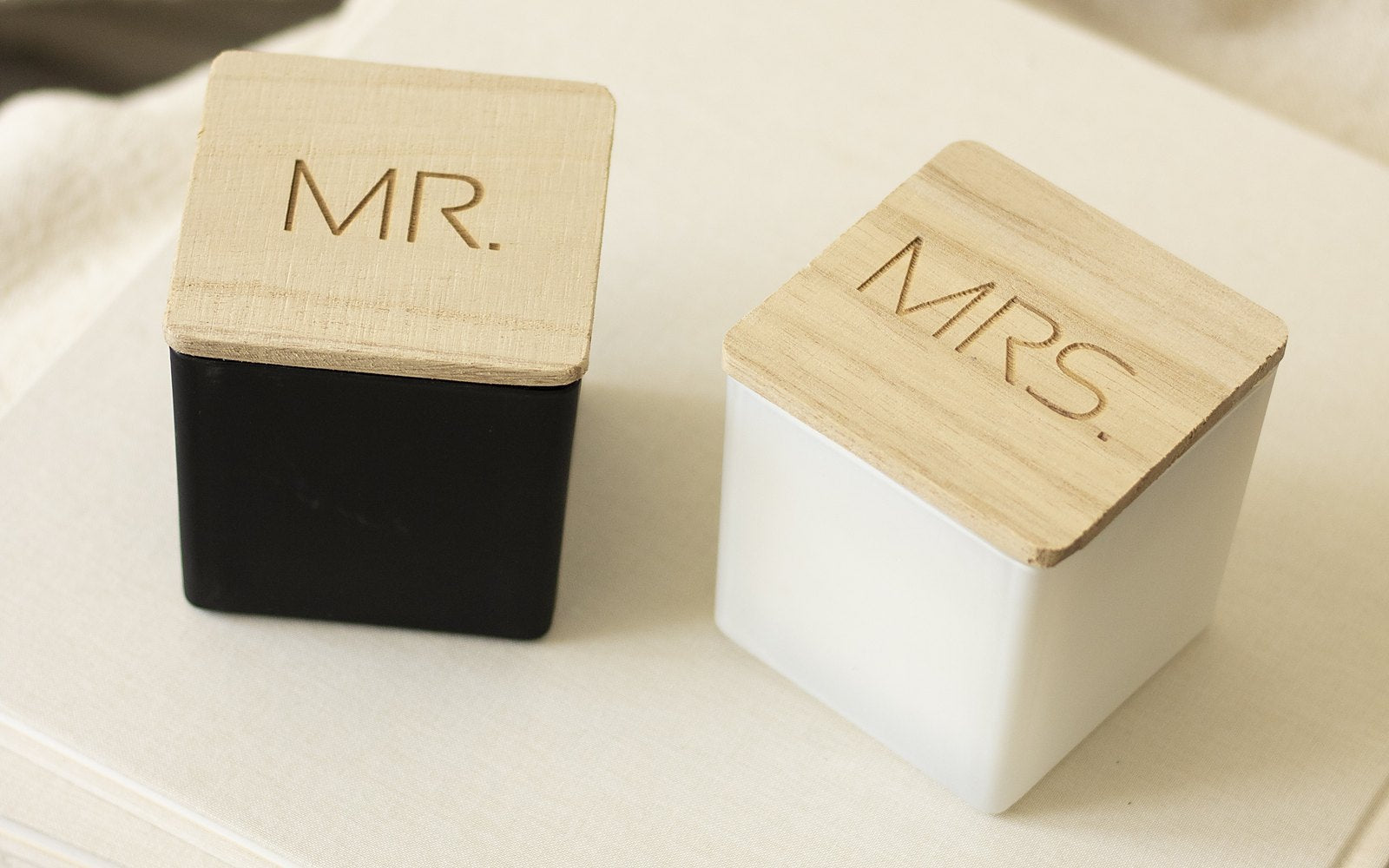 Mr. and Mrs. candles with engraved wooden lids, one black and one white